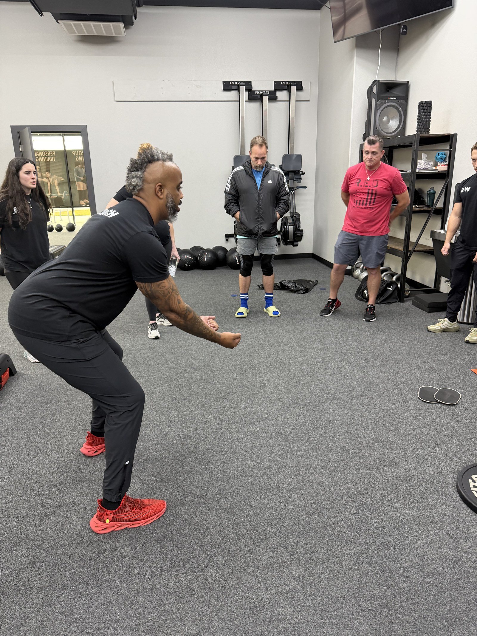 Real Wellness coach guiding members through a session